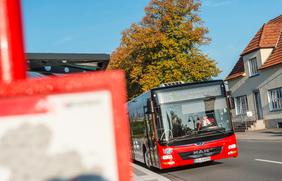 Bus der VOS fährt an Haltestelle mit Fahrplan in Osnabrück