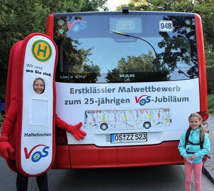 VOS-Maskottchen Haltelinchen und die Jungkünstlerin Carla von der Grundschule Glandorf vor ihrem „Bus-Kunstwerk“ 
